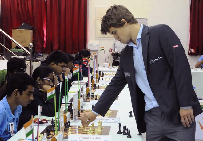 Mighty opponent: Magnus Carlsen playing against some of Tamil Nadu’s young chess players simultaneously at the MOP Vaishnav College in Chennai, in August, 2013. Carlsen had visited the city to observe the arrangements for the World Chess Championship match later that year against Viswanathan Anand. Vaishali, then 12, was one of four players to defeat Carlsen.